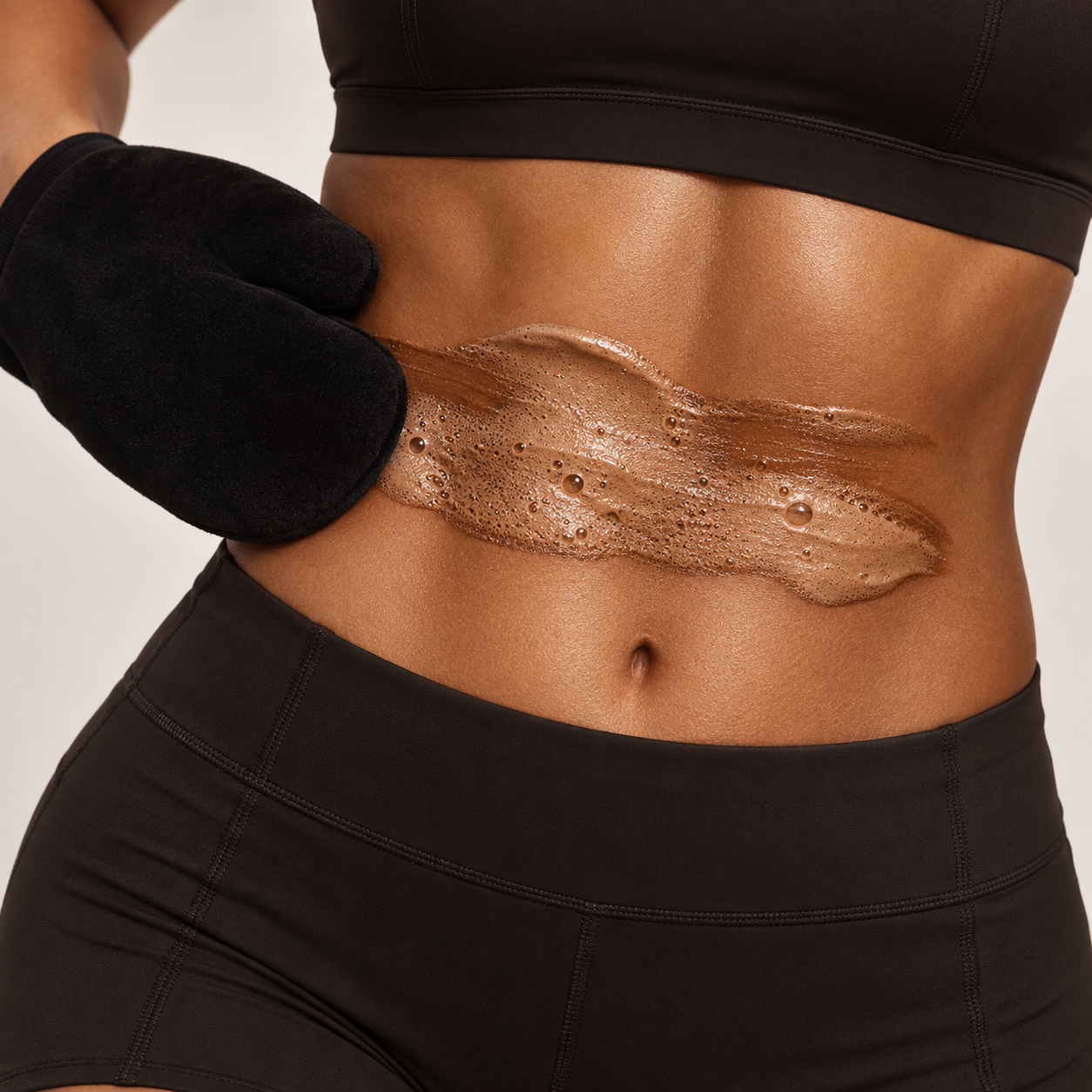 Self tan mousse applied with a velvet tanning mitt on prepped skin